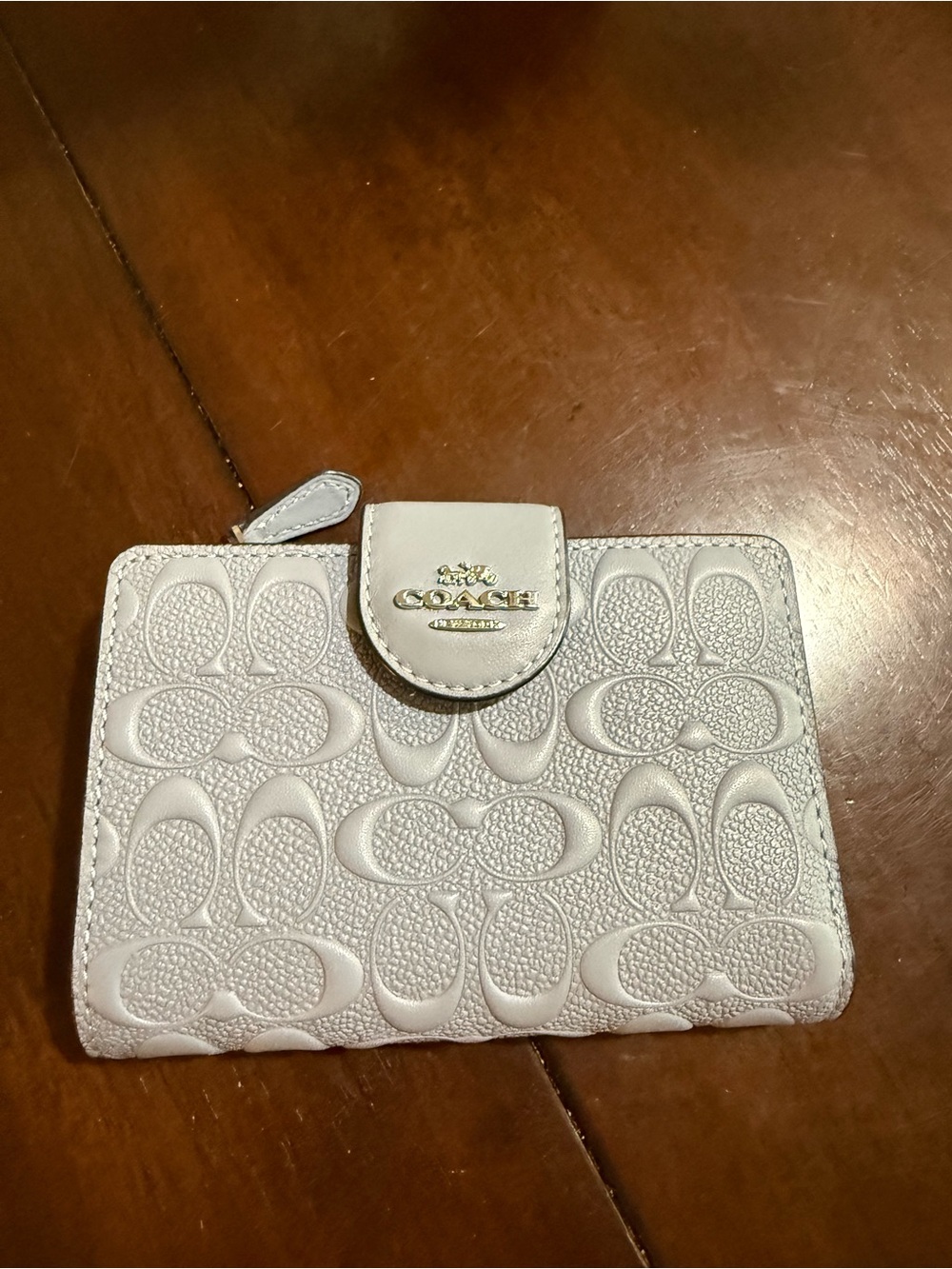 Coach Embossed Medium Corner Zip Wallet. Light blue with silver logo